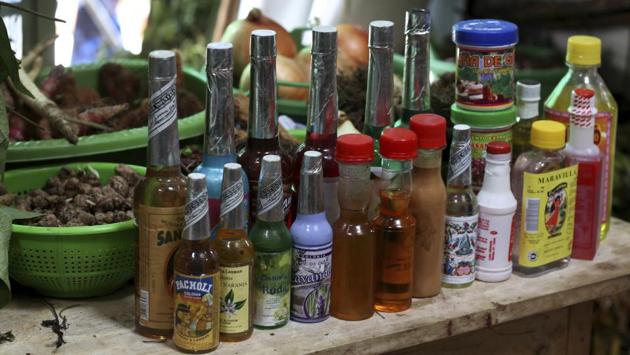Supplies for ayahuasca and Santeria rituals are displayed for sale in a market. Anthropologists say the region’s history of violence and lawlessness could be replicating itself in the virtually unregulated ayahuasca industry. In backwater towns aggressive English-speaking touts offering ceremonies greet tourists literally as they step off the boat, while in indigenous markets a bottle of the powerful tea fetches as much as $100. (Martin Mejia / AP)