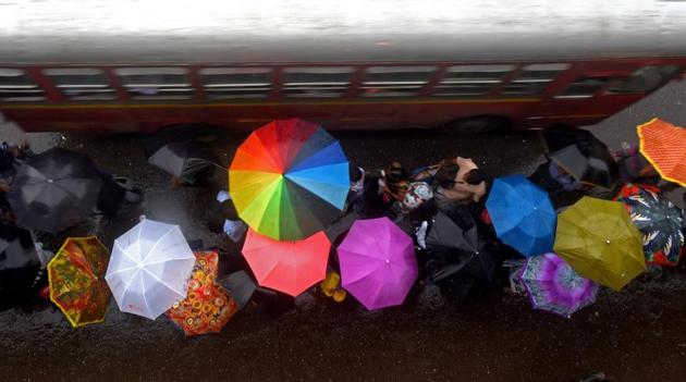 As middle-class aspirations are changing, people are spending less and less time in the rain, but spending more and more money on umbrellas.(Pratik Chorge/HT Photo)