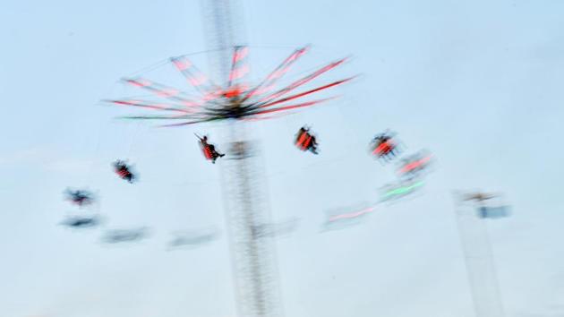 Revellers enjoy a ride as the sun sets during the Field Day Festival at Brockwell Park in London, Enngland. (Dylan Martinez / REUTERS)