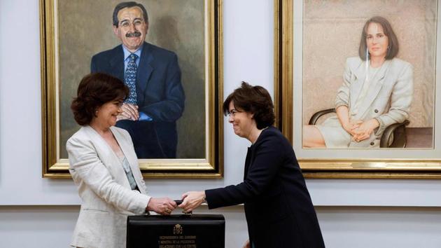Minister of equality Carmen Calvo (L) and former Deputy Prime Minister Soraya Saenz de Santamaria attend the portfolio handover ceremony on June 7. Calvo has also been given the high-profile role of deputy prime minister. That should give her more leeway to push policies in the areas of wage equality, women in leadership roles in big companies and against domestic violence. (Luca Piergiovanni / AFP)