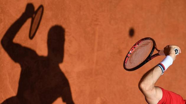 Croatia's Marin Cilic casts a shadow on court as he serves to Argentina's Juan Martin del Potro during their men's singles quarter-final match on day twelve of The Roland Garros 2018 French Open tennis tournament in Paris, France. (Christophe Archambault / AFP)