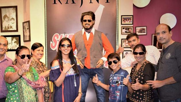Visitors with film star Rajnikanth’s wax figure installed at a wax museum in Nahargarh fort at Jaipur.(HT Photo)