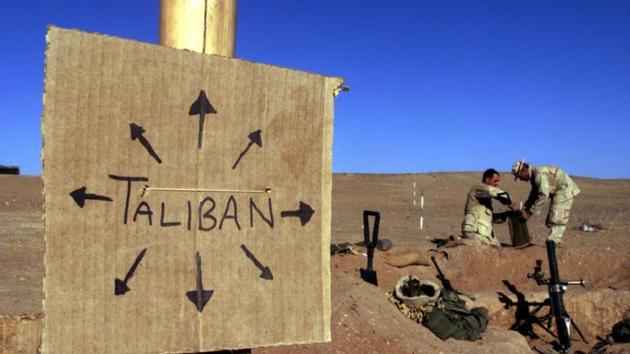 US Marines fill sand bags around their light mortar position on the front lines of the US Marine Corps base in southern Afghanistan. Nearby a cardboard sign reminding everyone that the Taliban forces could be anywhere and everywhere. (Reuters file photo) US Marines fill sand bags around their light mortar position on the front lines of the US Marine Corps base in southern Afghanistan. Nearby a cardboard sign reminding everyone that the Taliban forces could be anywhere and everywhere. (Reuters file photo)