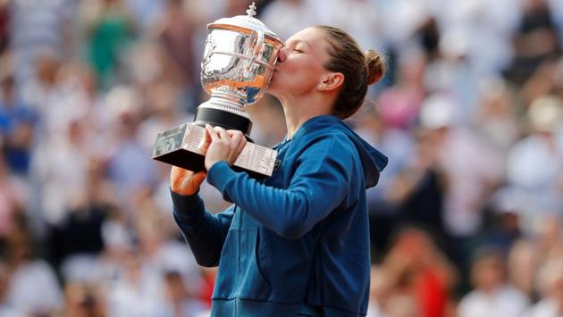 Halep celebrates by kissing the trophy. (REUTERS) Halep celebrates by kissing the trophy. (REUTERS)