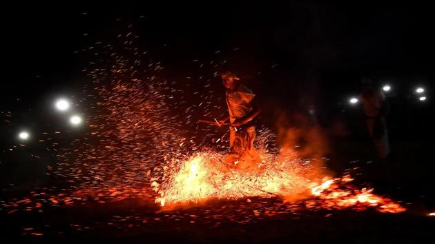 A priest of the Rabha tribal community runs over burning charcoal as he performs rituals during the Baikho festival in Ramyapur village, near Guwahati, Assam on June 9, 2018. The festival is celebrated for ensure the well being of the community and to ask for a good harvest. (Biju Boro / AFP) A priest of the Rabha tribal community runs over burning charcoal as he performs rituals during the Baikho festival in Ramyapur village, near Guwahati, Assam on June 9, 2018. The festival is celebrated for ensure the well being of the community and to ask for a good harvest. (Biju Boro / AFP)