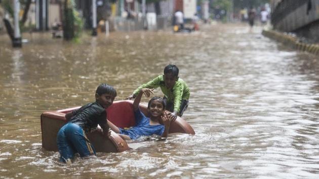 Children play in a waterlogged street after heavy rains at Hindamata, Parel in Mumbai, Maharashtra on June 9, 2018. (Pratik Chorge / HT Photo) Children play in a waterlogged street after heavy rains at Hindamata, Parel in Mumbai, Maharashtra on June 9, 2018. (Pratik Chorge / HT Photo)