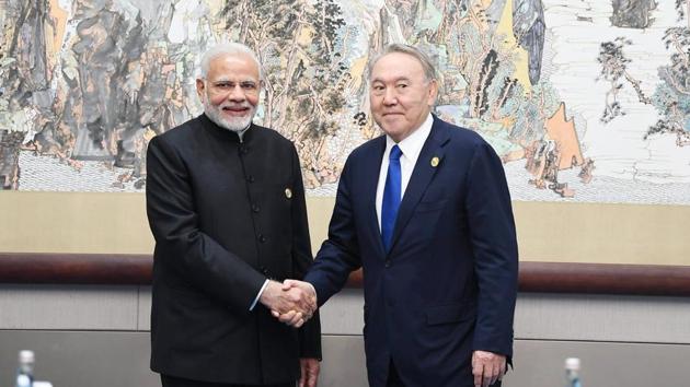 Prime Minister Narendra Modi meets Kazakhstan President Nursultan Nazarbayev on the sidelines of the Shanghai Cooperation Organisation (SCO) in Qingdao in the eastern Chinese port city on Sunday.(@MEAIndia Photo/Twitter)