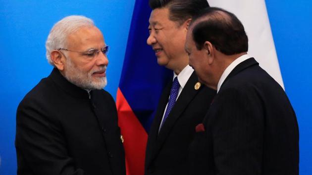 Pakistan's President Mamnoon Hussain shakes hands with Prime Minister Narendra Modi as China's President Xi Jinping walks behind them at a signing ceremony during Shanghai Cooperation Organization (SCO) summit in Qingdao, Shandong Province, China on June 10. (REUTERS) Pakistan's President Mamnoon Hussain shakes hands with Prime Minister Narendra Modi as China's President Xi Jinping walks behind them at a signing ceremony during Shanghai Cooperation Organization (SCO) summit in Qingdao, Shandong Province, China on June 10. (REUTERS)