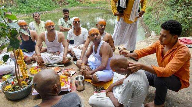 A group of farmers under the banner of Bharatiya Kisan Union got themselves tonsured in Misrod area of Bhopal and performed a ‘havan’ with a prayer that good sense prevails upon the government to address the farmers’ grievances in the state. (PTI Photo) A group of farmers under the banner of Bharatiya Kisan Union got themselves tonsured in Misrod area of Bhopal and performed a ‘havan’ with a prayer that good sense prevails upon the government to address the farmers’ grievances in the state. (PTI Photo)