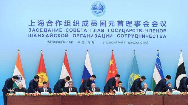 India's Prime Minister Narendra Modi, Kyrgyzstan's President Sooronbay Jeenbekov, Tajikistan's President Emomali Rahmon, Russia's President Vladimir Putin, China's President Xi Jinping, Kazakhstan's President Nursultan Nazarbayev, Uzbekistan's President Shavkat Mirziyoyev and Pakistan's President Mamnoon Hussain attend a signing ceremony during the Shanghai Cooperation Organization (SCO) summit in Qingdao, China. (REUTERS) India's Prime Minister Narendra Modi, Kyrgyzstan's President Sooronbay Jeenbekov, Tajikistan's President Emomali Rahmon, Russia's President Vladimir Putin, China's President Xi Jinping, Kazakhstan's President Nursultan Nazarbayev, Uzbekistan's President Shavkat Mirziyoyev and Pakistan's President Mamnoon Hussain attend a signing ceremony during the Shanghai Cooperation Organization (SCO) summit in Qingdao, China. (REUTERS)