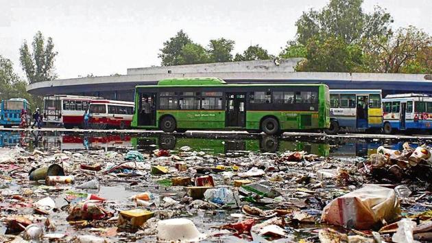 Water and garbage accumulated at the bus stand near Mahavir Chowk after four hours of moderate rain. Unlike the Hero Honda Chowk, the filth had not been cleared till Sunday afternoon, inconveniencing residents. (YOGENDRA KUMAR/HT PHOTO) Water and garbage accumulated at the bus stand near Mahavir Chowk after four hours of moderate rain. Unlike the Hero Honda Chowk, the filth had not been cleared till Sunday afternoon, inconveniencing residents. (YOGENDRA KUMAR/HT PHOTO)