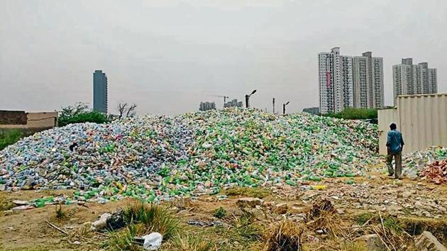 Officials said the stack of plastic waste on the 1,000 square yard plot is around seven feet high, taller than the boundary wall.(HT Photo/Pankaj Gupta)