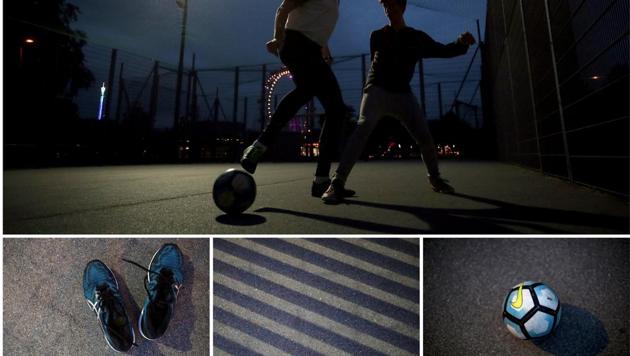 Young men play one-on-one in front of the Giant Ferris Wheel in Vienna, Austria. Soccer is simple. Be it be the rules, lack of high end equipments and skills, or ones social background, football is a game played via moving circular body. (Lisi Niesner / REUTERS)