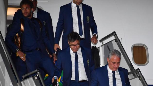 Brazil's forward Neymar (L) and coach Tite (R) descend from the plane upon the team's arrival at Sochi airport. (AFP) Brazil's forward Neymar (L) and coach Tite (R) descend from the plane upon the team's arrival at Sochi airport. (AFP)