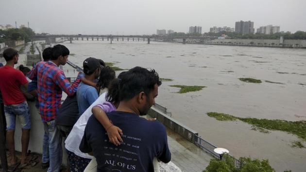 People look at a flooded River Sabarmati in Ahmadabad, India.(AP Representative Photo)