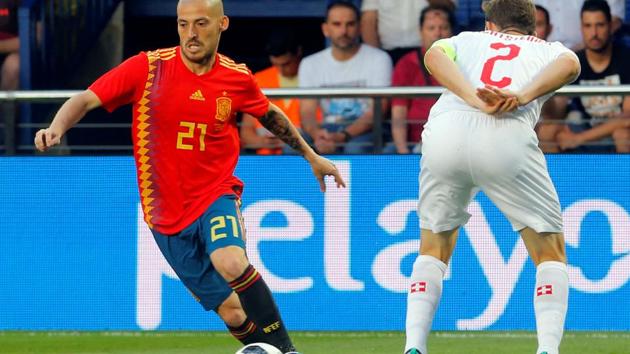 Spain's David Silva (red) in action with Switzerland's Stephan Lichtsteiner.(REUTERS)
