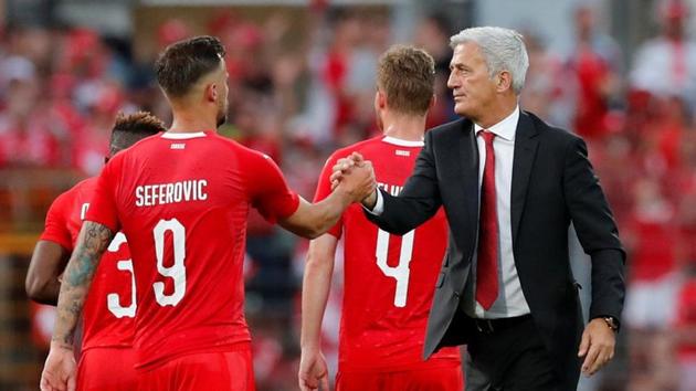 Switzerland striker Haris Seferovic shakes hands with coach Vladimir Petkovic.(REUTERS)