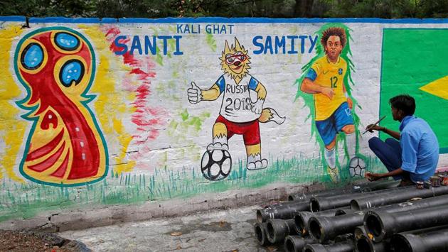 A painter applies finishing touches to an image of Brazil's Marcelo. (REUTERS)
