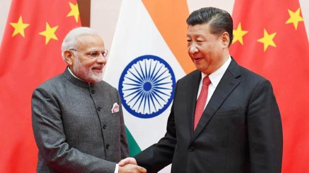 India's Prime Minister Narendra Modi shakes hands with Chinese President Xi Jinping during the 18th Shanghai Cooperation Organisation (SCO) Summit in Qingdao, China, June 9, 2018. India's Press Information Bureau/Handout via REUTERS