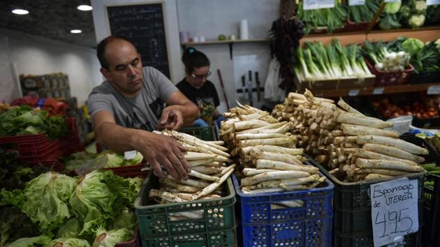 A trader organises white asparagus for customers at his store in Pamplona, northern Spain. The price can double or triple in food markets and even further when served in restaurants, where the bill for a dish of three or four cooked asparagus dressed with olive oil, vinaigrette or mayonnaise begins at nine euros ($10.60). (Alvaro Barrientos / AP) A trader organises white asparagus for customers at his store in Pamplona, northern Spain. The price can double or triple in food markets and even further when served in restaurants, where the bill for a dish of three or four cooked asparagus dressed with olive oil, vinaigrette or mayonnaise begins at nine euros ($10.60). (Alvaro Barrientos / AP)