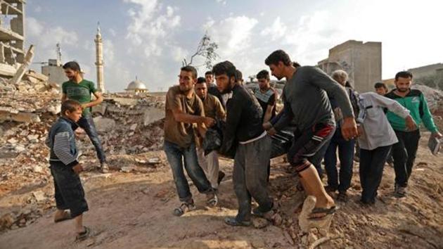 Syrian rescuers and civilians recover bodies in Zardana, in the mostly rebel-held northern Syrian Idlib province, in the aftermath of air strikes in the area, on June 8, 2018. (AFP File Photo) Syrian rescuers and civilians recover bodies in Zardana, in the mostly rebel-held northern Syrian Idlib province, in the aftermath of air strikes in the area, on June 8, 2018. (AFP File Photo)