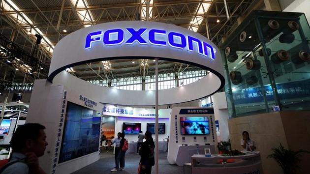 Visitors are seen at a Foxconn booth at the World Intelligence Congress in Tianjin, China.(REUTERS File Photo)