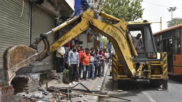 Municipal Corporation of Delhi (MCD) officials demolish encroachments during an anti-encroachment drive at Rajendra Nagar in New Delhi. (Sanchit Khanna / HT Photo)