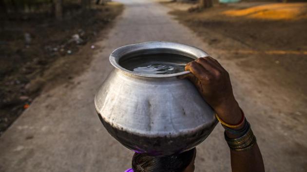 A woman walks to collect water in Dumarpani village, Chattisgarh. Globally around 844 million people struggle to access water. And while access itself remains a hard reality for millions in India, the quality of water accessed is a greater issue among some of the most impoverished people and regions. (Prashanth Vishwanathan / WaterAid)