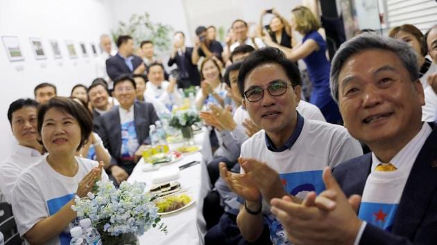 Koreans watch as US President Donald Trump meets North Korean leader Kim Jong Un, on television at the Korean Association in Singapore. A more sober-sounding Kim said: “It was not easy to get here. The past worked as fetters on our limbs, and the old prejudices and practices worked as obstacles on our way forward. But we overcame all of them, and we are here today.” (Tyrone Siu / REUTERS)