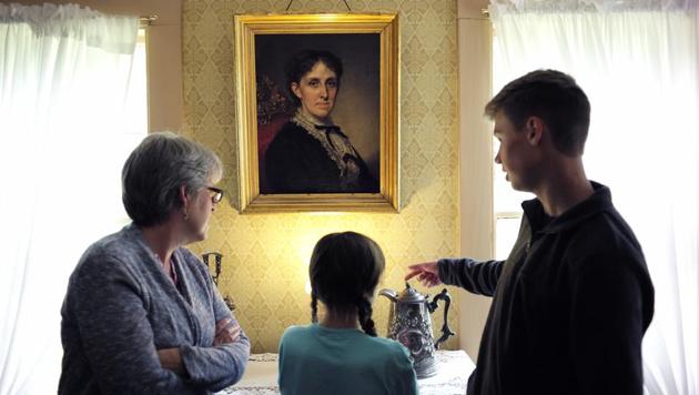 Visitors stand by a portrait of Alcott by George Healy. One of Alcott’s goals was to lift her family out of poverty. She took various jobs and was in one instance, a live-in companion for the sick sister of a man named James Richardson who had her spend evenings listening to him reading romantic poetry. He started slipping suggestive notes and gave her back-breaking work as she rejected his advances. (Steven Senne / AP)