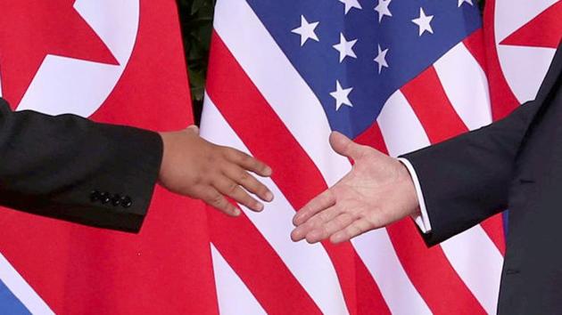 US President Donald Trump shakes hands with North Korean leader Kim Jong Un at the Capella Hotel. The two leaders shook hands for around 13 seconds in front of a row of alternating US and North Korean flags. They then moved into a roughly 40-minute one-on-one meeting, joined only by their interpreters before including their advisers for bilateral talks and then proceeding to a working lunch. (Jonathan Ernst / REUTERS)