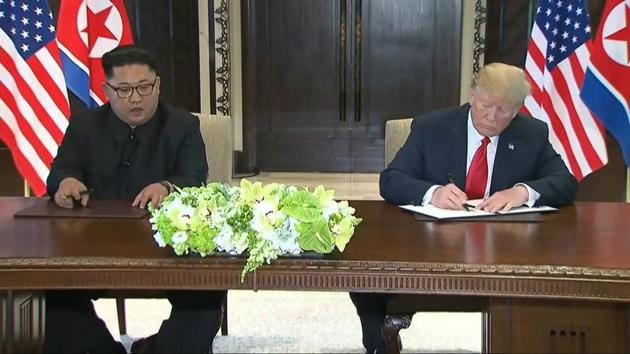 In this image made from video provided by Host Broadcaster Mediacorp Pte Ltd, US President Donald Trump, right, signs an agreement with North Korean leader Kim Jong Un after their meeting at Capella Hotel in Singapore, June 12, 2018.(AP Photo) In this image made from video provided by Host Broadcaster Mediacorp Pte Ltd, US President Donald Trump, right, signs an agreement with North Korean leader Kim Jong Un after their meeting at Capella Hotel in Singapore, June 12, 2018.(AP Photo)