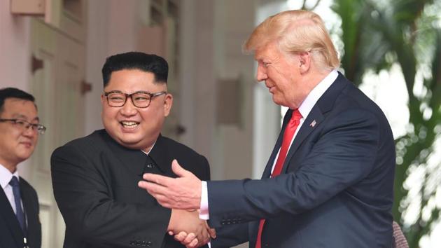 US President Donald Trump shakes hands with North Korea's leader Kim Jong Un as they meet at the start of their historic US-North Korea summit, at the Capella Hotel on Sentosa island in Singapore on June 12, 2018. (AFP)