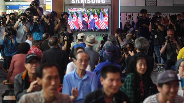 People watch a television screen showing live footage of the summit in South Korea. “I feel really great,” Trump said. “It’s gonna be a great discussion and I think tremendous success. I think it’s gonna be really successful and I think we will have a terrific relationship, I have no doubt.” (Jung Yeon-je / AFP)
