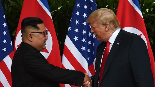 North Korea's leader Kim Jong Un (left) shakes hands with US President Donald Trump (right) after taking part in a signing ceremony at the end of their historic US-North Korea summit, at the Capella Hotel on Sentosa island in Singapore.(AFP Photo)