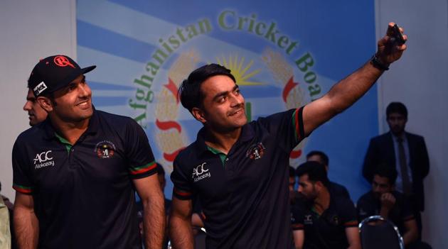 Afghan spinners Rashid Khan (R), Mohammed Nabi (L) and Mujeeb ur Rahman (not pictured) will no doubt be challenged by the transition from bowling with a white ball to the red ball.(AFP)