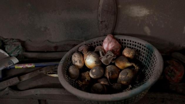 Onions sit drying at a house affected by the eruption at San Miguel Los Lotes in Escuintla. Guatemalan authorities reacted slowly to signs of Fuego’s impending eruption on June 3, contributing to one of the most tragic natural disasters in recent Guatemalan history. (Carlos Jasso / REUTERS)
