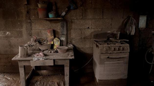 The kitchen of a house is seen covered in ash. “My family was having lunch, they left the plates of food and stopped eating and fled,” said Pedro Gomez, a 45-year-old welder. “They took nothing but the clothes on their backs.” (Carlos Jasso / REUTERS)