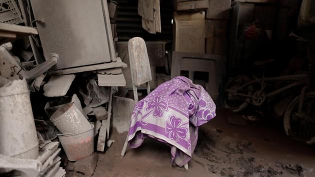 A blanket lies on a chair inside a house at San Miguel Los Lotes. Many lost 10 to 50 relatives each, descendants of intertwining generations of small families who settled in Los Lotes more than 40 years ago. They refuse to give up hope of finding relatives --or at least their remains. (Carlos Jasso / REUTERS)