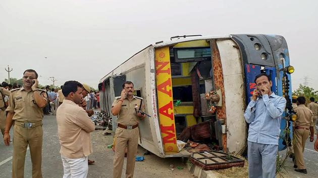 Police personnel investigate the site where an allegedly speeding bus overturned after hitting a road divider in Mainpuri on Wednesday. More than a dozen people were killed and a dozen others injured when the private tourist bus lost control. It was travelling from Rajasthan’s Jaipur to Farukkhabad in Uttar Pradesh when the accident occurred near Kiratpur village around 5am. (PTI)