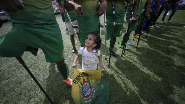 A young fan of the El Empalme team stands with players. “I want to show the world I can be the Messi of the amputees,” said a smiling Holger Velez, 28, the playmaker for El Empalme. (Dolores Ochoa / AP) A young fan of the El Empalme team stands with players. “I want to show the world I can be the Messi of the amputees,” said a smiling Holger Velez, 28, the playmaker for El Empalme. (Dolores Ochoa / AP)