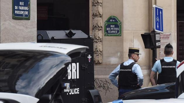 Gendarmes stand next to a Police BRI intervention brigade vehicle on June 12, 2018 in central Paris near the site where an armed man had taken hostages. (AFP) Gendarmes stand next to a Police BRI intervention brigade vehicle on June 12, 2018 in central Paris near the site where an armed man had taken hostages. (AFP)
