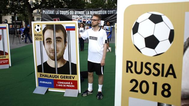 Members of Reporters Without Borders (RSF) hold giants portraits representing imprisoned Russian journalists. (AP) Members of Reporters Without Borders (RSF) hold giants portraits representing imprisoned Russian journalists. (AP)