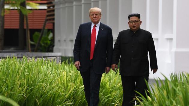 North Korea's leader Kim Jong Un with US President Donald Trump during a break in talks at their historic US-North Korea summit, at the Capella Hotel on Sentosa island in Singapore on June 12, 2018. (AFP) North Korea's leader Kim Jong Un with US President Donald Trump during a break in talks at their historic US-North Korea summit, at the Capella Hotel on Sentosa island in Singapore on June 12, 2018. (AFP)