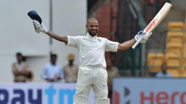 Shikhar Dhawan celebrates his century during day one of the Test match between India and Afghanistan at the M Chinnaswamy Stadium in Bangalore.(AFP)
