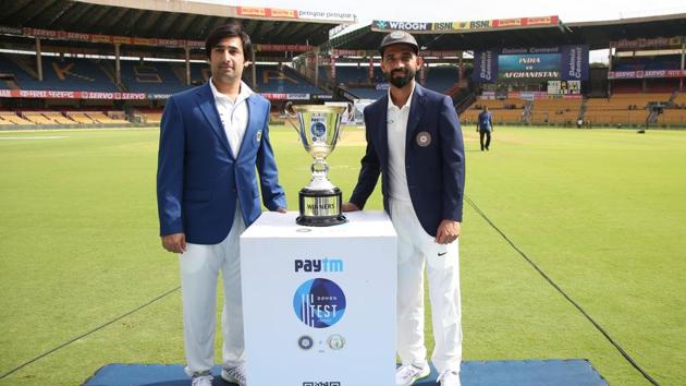 Both captains pose with the trophy as Afghanistan entered the elite club of nations to play Test cricket. (BCCI) 