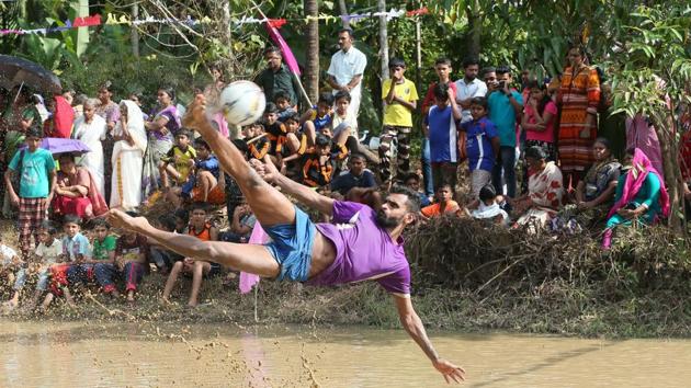 Indian footballer C K Vineeth in action during an exhibition match in the monsoon-drenched paddy fields of north Kerala. The FIFA World Cup 2018 kicks off in Russia today, but visitors to Kerala these past days may well have mistaken the southern state as this year’s host with the sort of football frenzy on display. (K Sasi / HT Photo)