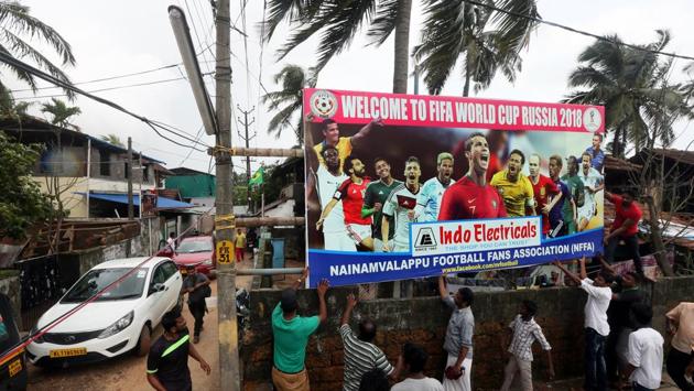 Boards, festoons and banners welcoming the World Cup dot Kozhikkode and Malappuram districts. Founded in 1996, the Nainamvalappu Football Fans Association for one has been in constant touch with FIFA for news and periodicals about the event. Homes in the area are celebrating with flags of their favourite teams perched atop. (K Sasi / HT Photo) Boards, festoons and banners welcoming the World Cup dot Kozhikkode and Malappuram districts. Founded in 1996, the Nainamvalappu Football Fans Association for one has been in constant touch with FIFA for news and periodicals about the event. Homes in the area are celebrating with flags of their favourite teams perched atop. (K Sasi / HT Photo)