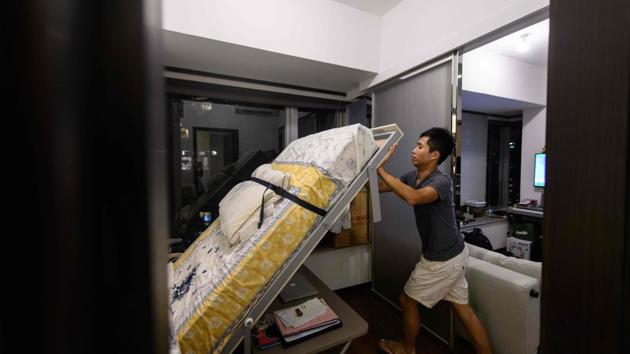 Law’s studio is a fraction bigger at 292 square feet, with a price per square foot of nearly HK$20,000. He has adapted to the limited space by buying transformable furniture -- his bed folds away against the wall to reveal a desk tucked underneath -- and he keeps most of his belongings at his parents’ home. (Isaac Lawrence / AFP)