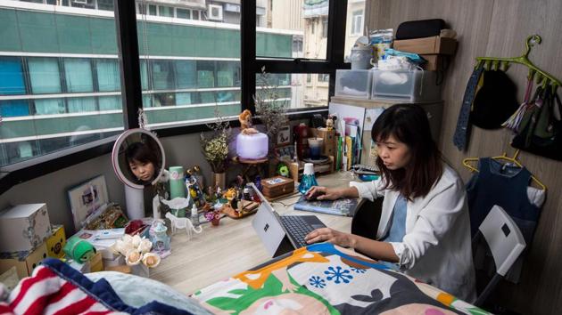 Property prices have been fuelled by wealthy mainland Chinese investors and developers. Rental prices have also rocketed and the wait for government-subsidised housing can be five years. Many poorer Hong Kong residents like Jezz Ng, 29, resort to renting dingy “subdivided” flats rather than shelling out for a space. At weekends she goes home to her parents. (Isaac Lawrence / AFP)